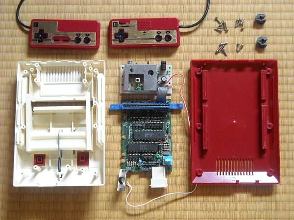 Famicom ouverte avec ses composants internes visibles pour montrer les zones à vérifier lors de la réparation